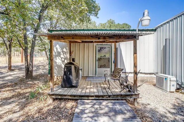 a view of a backyard with table and chairs and wooden fence