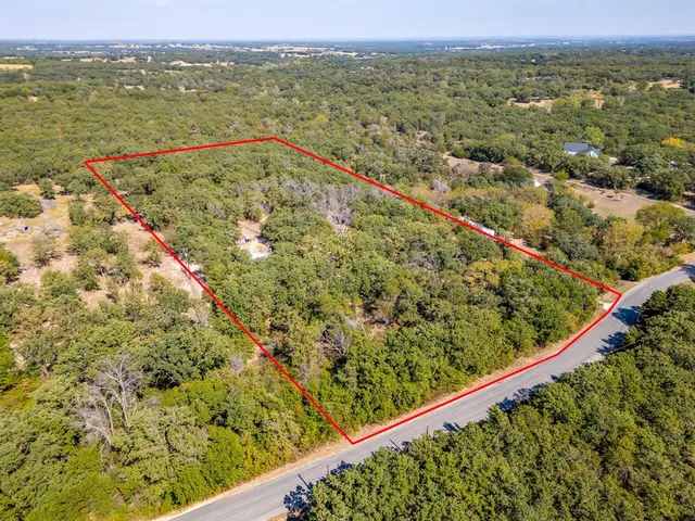 a view of a green field with an outdoor space