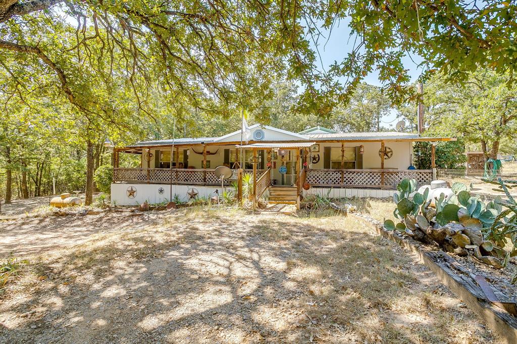 436 Luke Road Springtown, TX 76082 - Photo 5 of 39 a house view with swimming pool in front of it