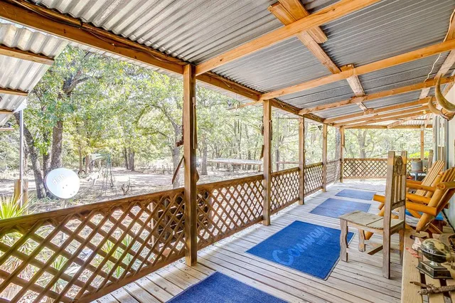 a view of a porch with wooden floor