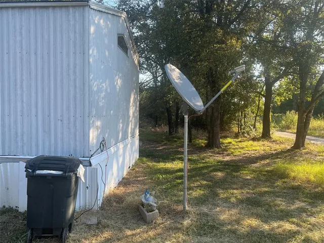 a view of a house with a yard and deck