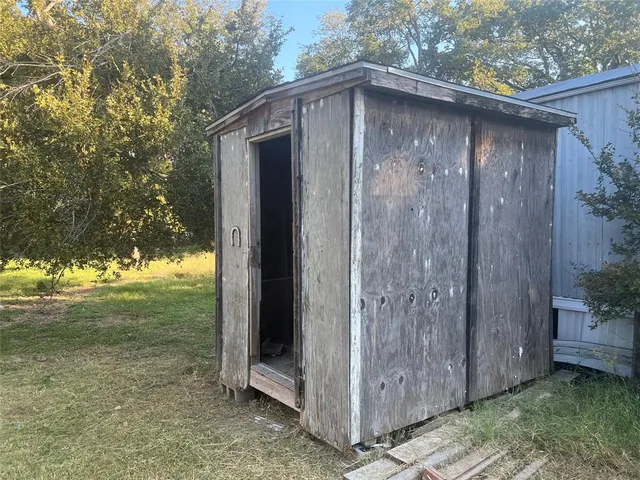 a backyard of a house with lots of green space and lake view