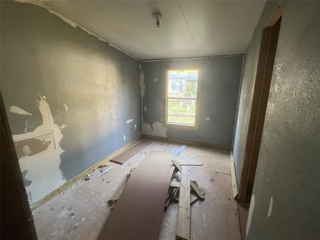 a backyard of a house with barbeque oven and seating space