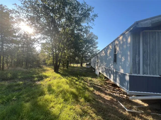 a view of a yard with a tree