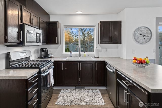 a kitchen with a sink appliances and cabinets
