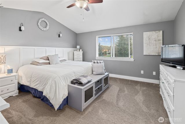 a bed room with a bed and a tv