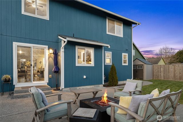 a view of a patio with couches table and chairs and potted plants
