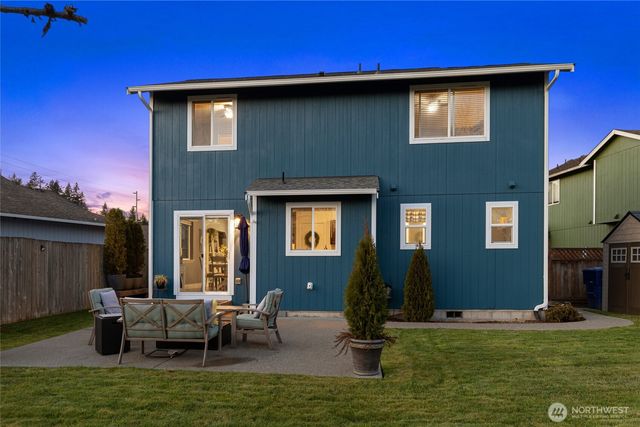 a backyard of a house with yard fire pit and outdoor seating