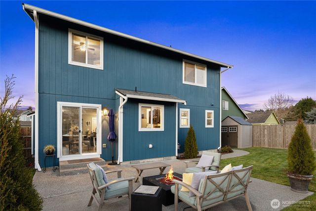 a backyard of a house with outdoor seating