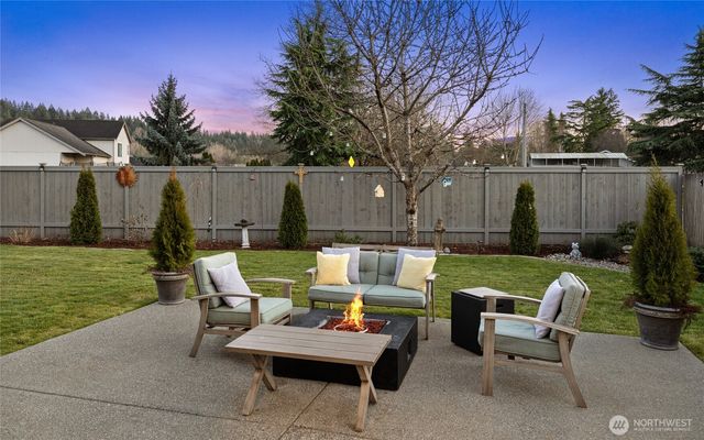 a view of backyard with seating area and green space