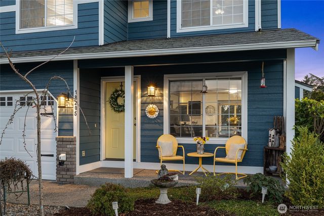 a couple of table and chairs in front of building