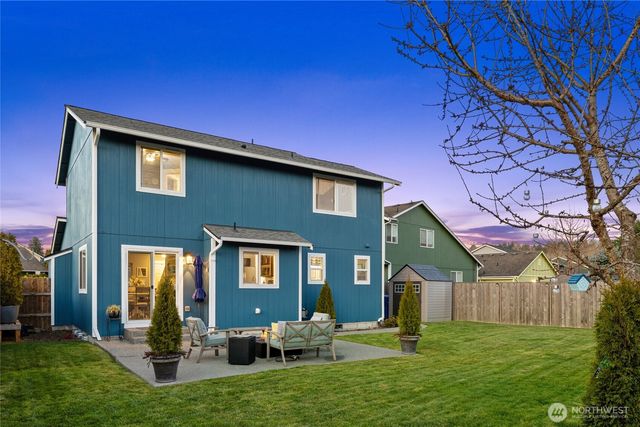 a backyard of a house with yard fire pit and outdoor seating