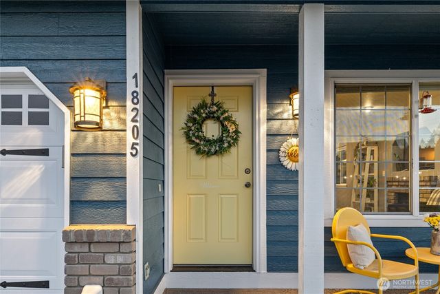 a view of a porch with a table and chairs