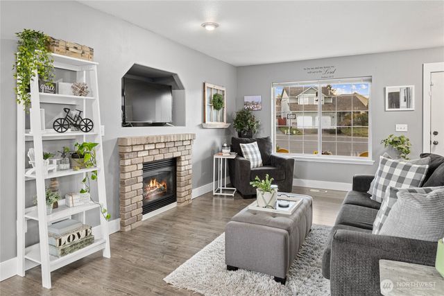 a living room with furniture a flat screen tv and a fireplace