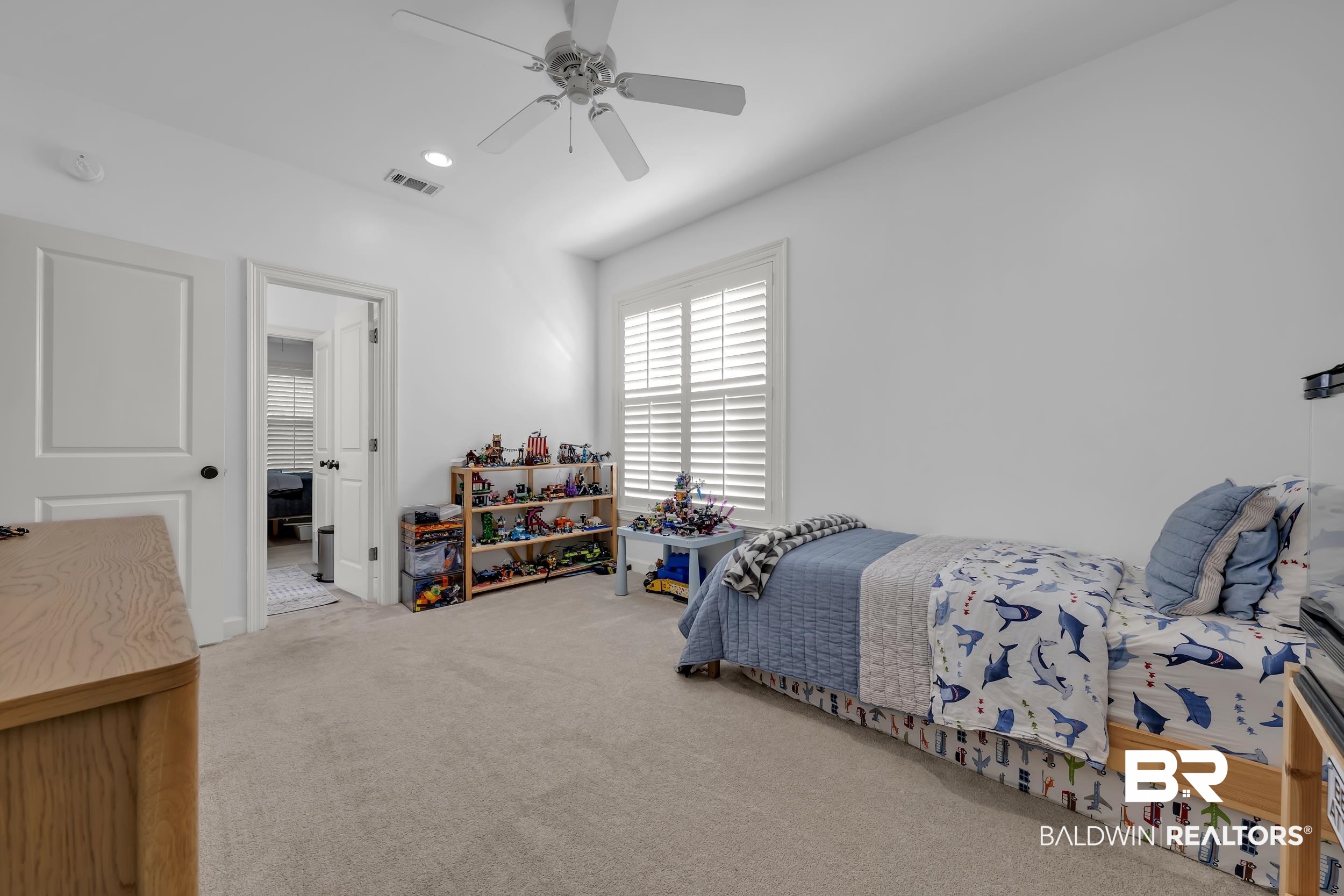 8137 Pine Run Daphne, AL 36527 - Photo 32 of 67 Light-filled room featuring neutral carpet flooring, white walls, a ceiling fan, and a window with plantation shutters