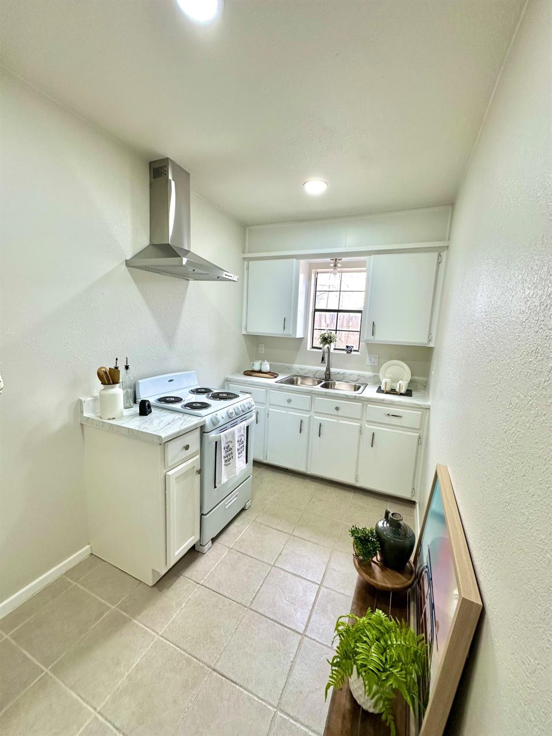 101 15th Street Levelland, TX 79336 - Photo 26 of 29 a kitchen with a stove cabinets and a sink