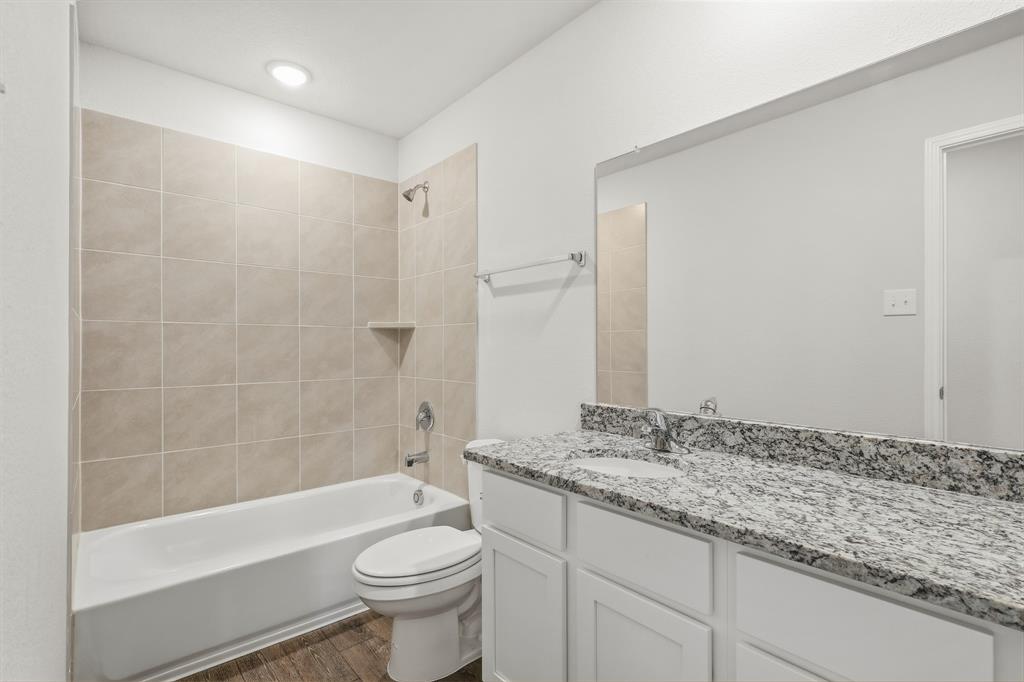 10612 Brocket Lane Crowley, TX 76036 - Photo 15 of 35 a bathroom with a granite countertop sink a toilet and bathtub