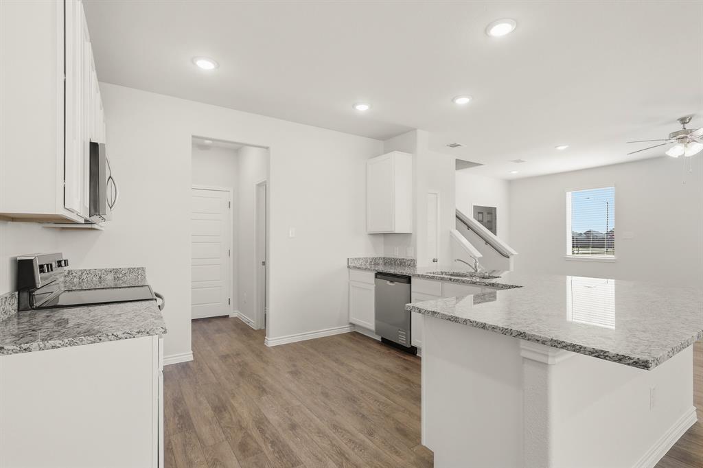 10612 Brocket Lane Crowley, TX 76036 - Photo 2 of 35 a kitchen with stainless steel appliances granite countertop a sink and a stove top oven
