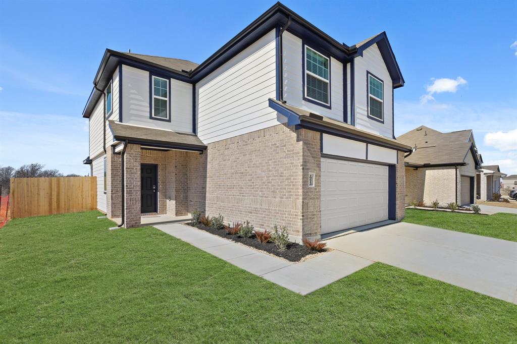 10612 Brocket Lane Crowley, TX 76036 - Photo 3 of 35 a front view of a house with a yard and garage