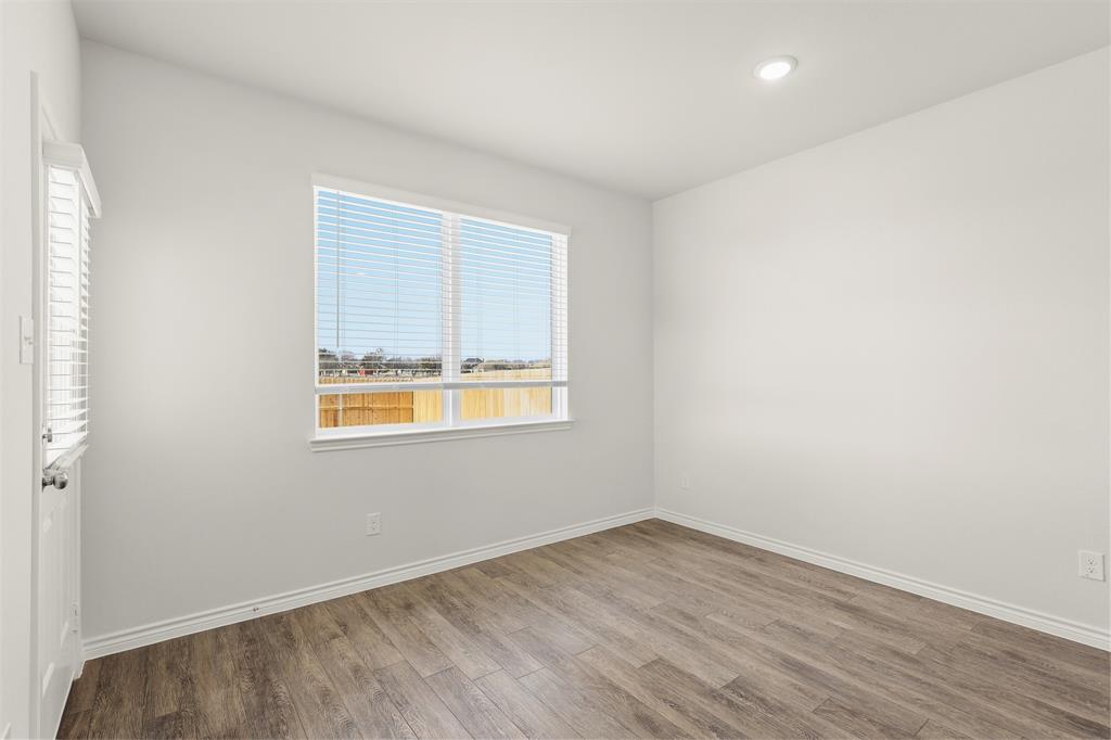 10612 Brocket Lane Crowley, TX 76036 - Photo 6 of 35 an empty room with wooden floor and windows