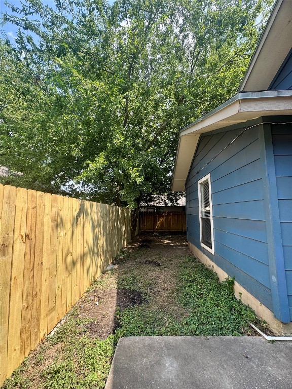 5011 Copperbend Boulevard, Unit A Austin, TX 78744 - Photo 16 of 18 a backyard of a house with lots of green space
