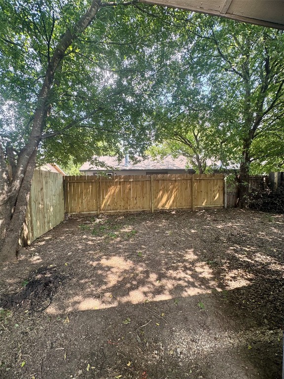 5011 Copperbend Boulevard, Unit A Austin, TX 78744 - Photo 17 of 18 a view of a yard with a tree