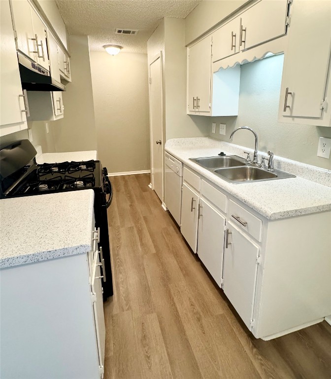 5011 Copperbend Boulevard, Unit A Austin, TX 78744 - Photo 4 of 18 a kitchen with sink a stove and refrigerator