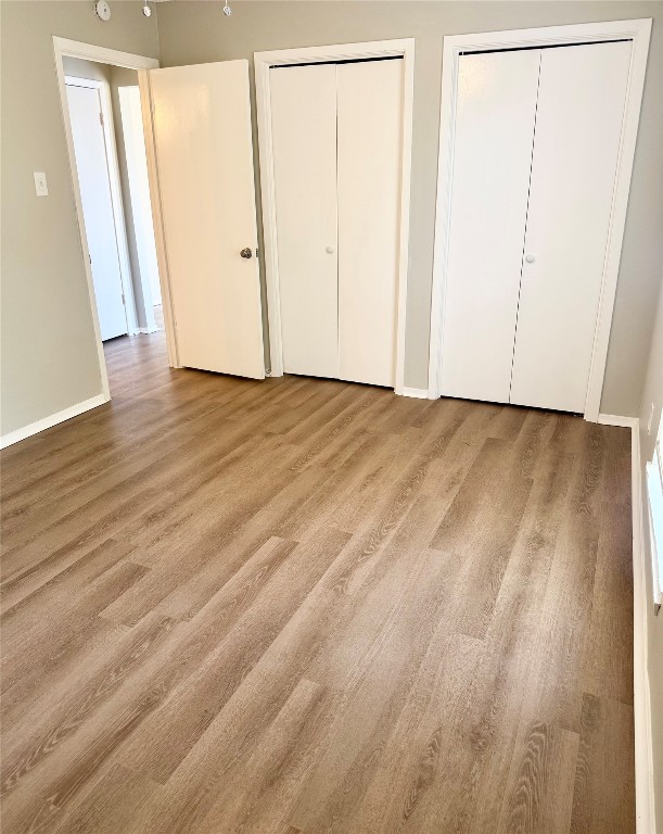 5011 Copperbend Boulevard, Unit A Austin, TX 78744 - Photo 10 of 18 an empty room with wooden floor and entrance