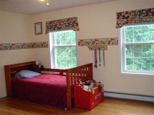 108 Fitch Road Lancaster, MA 01523 - Photo 9 of 20 a bed sitting in a bedroom next to a window