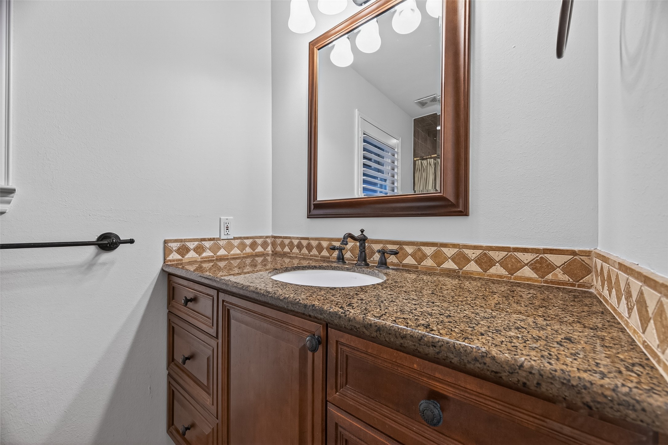 5638 Sanford Road Houston, TX 77096 - Photo 29 of 41 The primary bathroom showcases granite countertops, custom backsplash tile work, and custom cabinetry for a classic and timeless look.