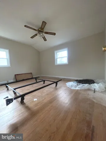 a room with a wooden floor and white walls