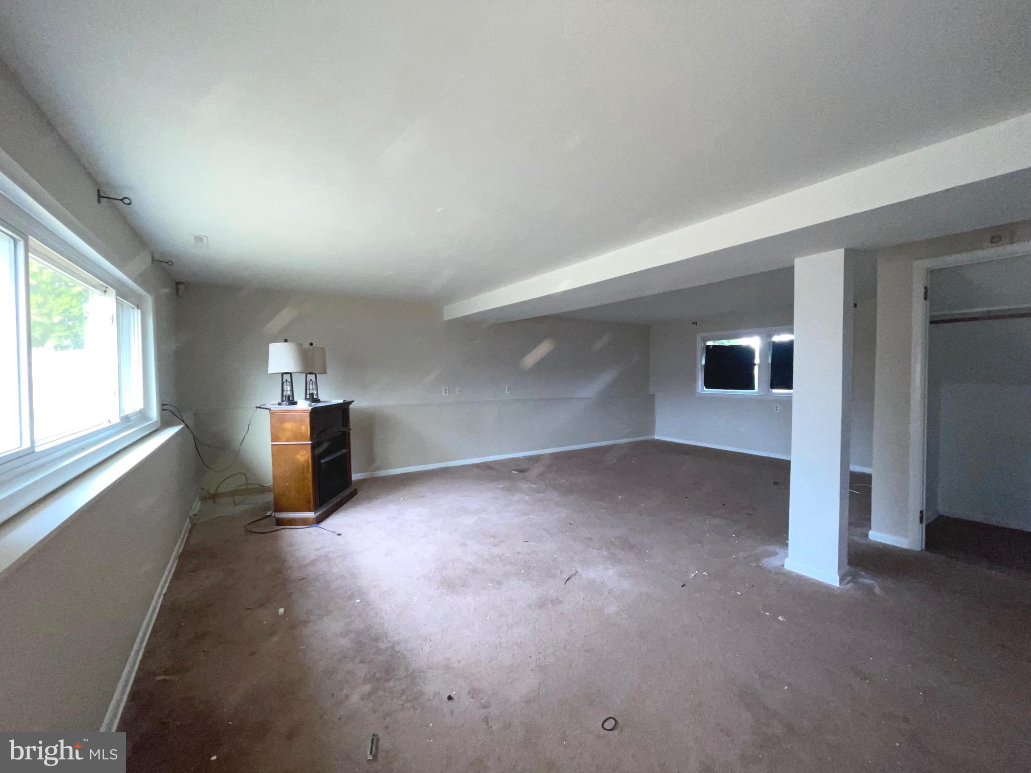 292 Justice Drive Carneys Point, NJ 08069 - Photo 15 of 17 an empty room with fireplace and windows