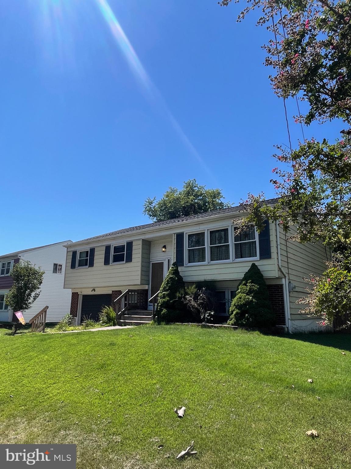 292 Justice Drive Carneys Point, NJ 08069 - Photo 2 of 17 a front view of a house with a garden and yard