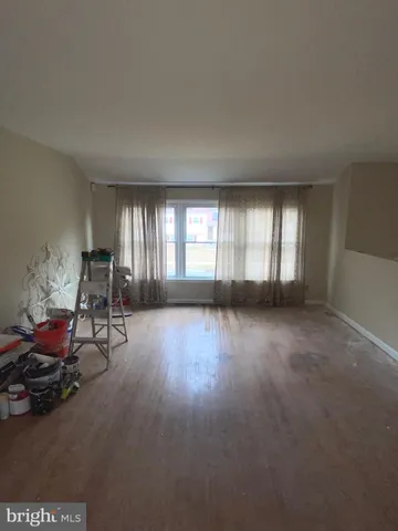 a view of room with furniture and wooden floor
