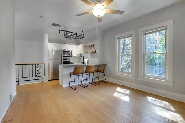 a view of a livingroom with furniture window and wooden floor