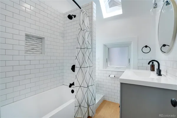 a bathroom with a sink a bathtub and shower