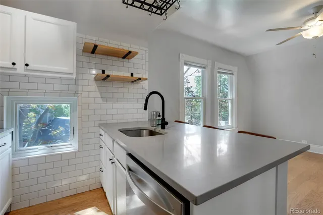 a view of a kitchen with a sink and cabinets