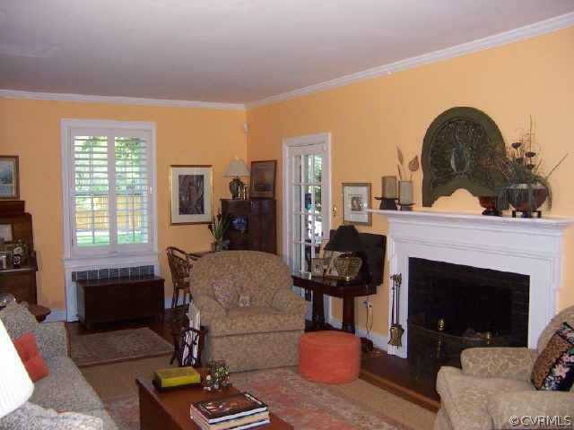 7200 River Road Richmond, VA 23229 - Photo 4 of 10 a living room with furniture a fireplace and large windows