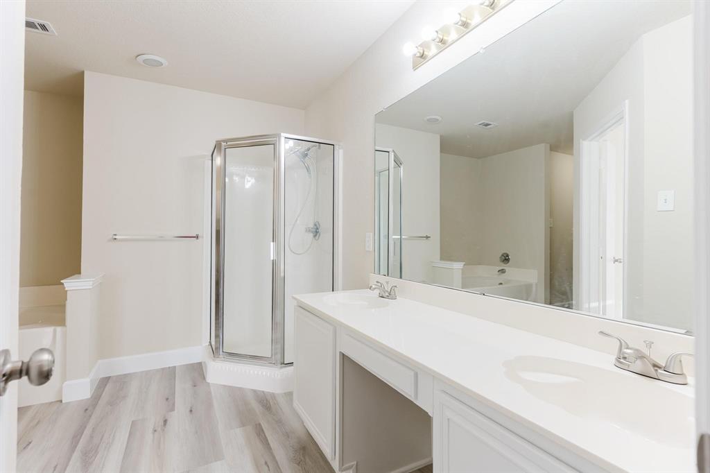 2109 Windjammer Way Rowlett, TX 75088 - Photo 10 of 21 Bathroom with a bath, double vanity, a shower stall, and light wood finished floors