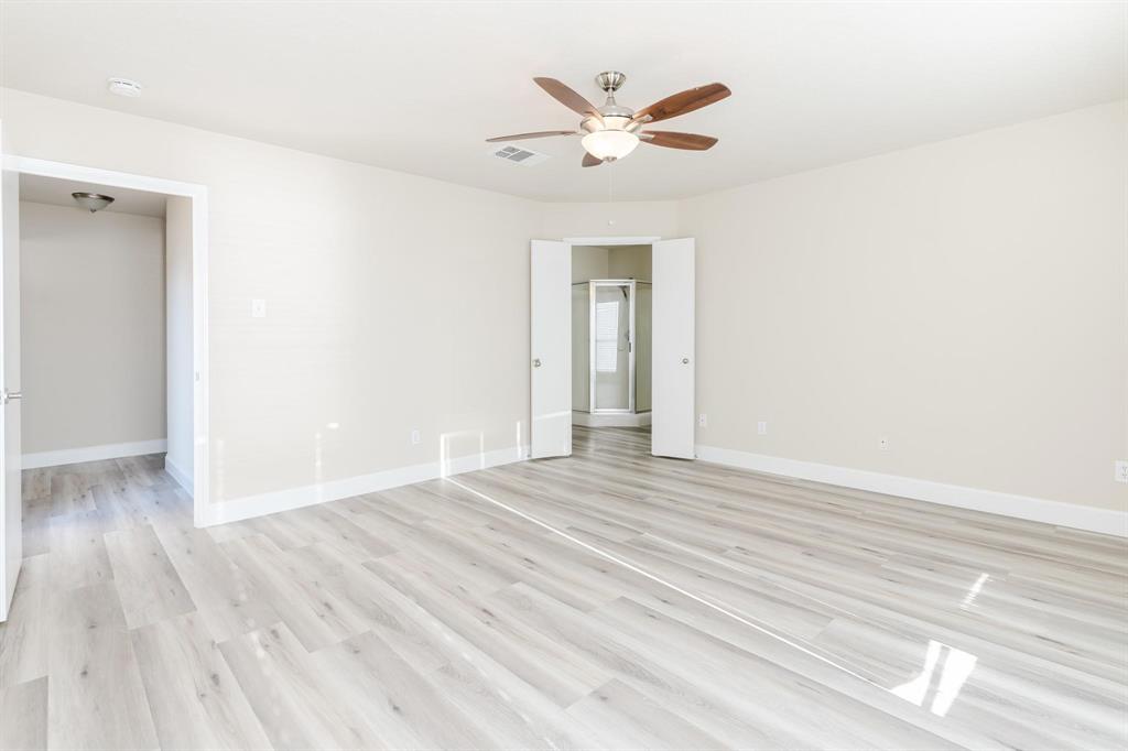 2109 Windjammer Way Rowlett, TX 75088 - Photo 12 of 21 Unfurnished room with light wood-type flooring and ceiling fan