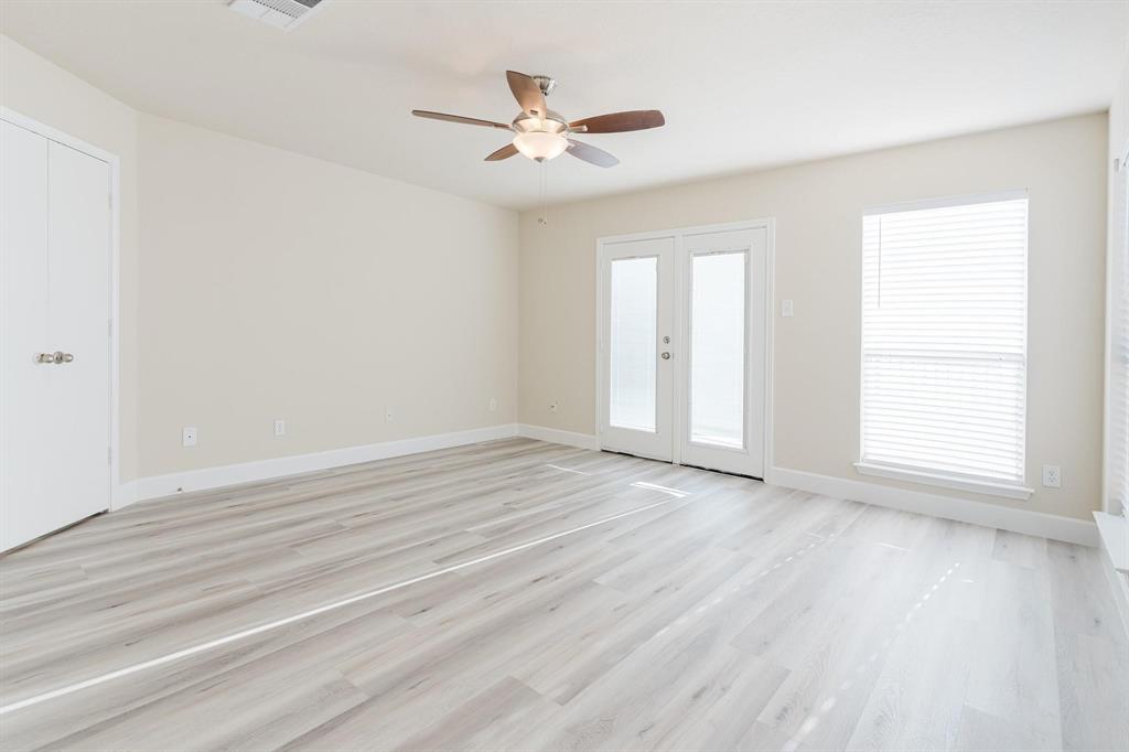 2109 Windjammer Way Rowlett, TX 75088 - Photo 13 of 21 Unfurnished room with light wood-type flooring, a ceiling fan, and french doors