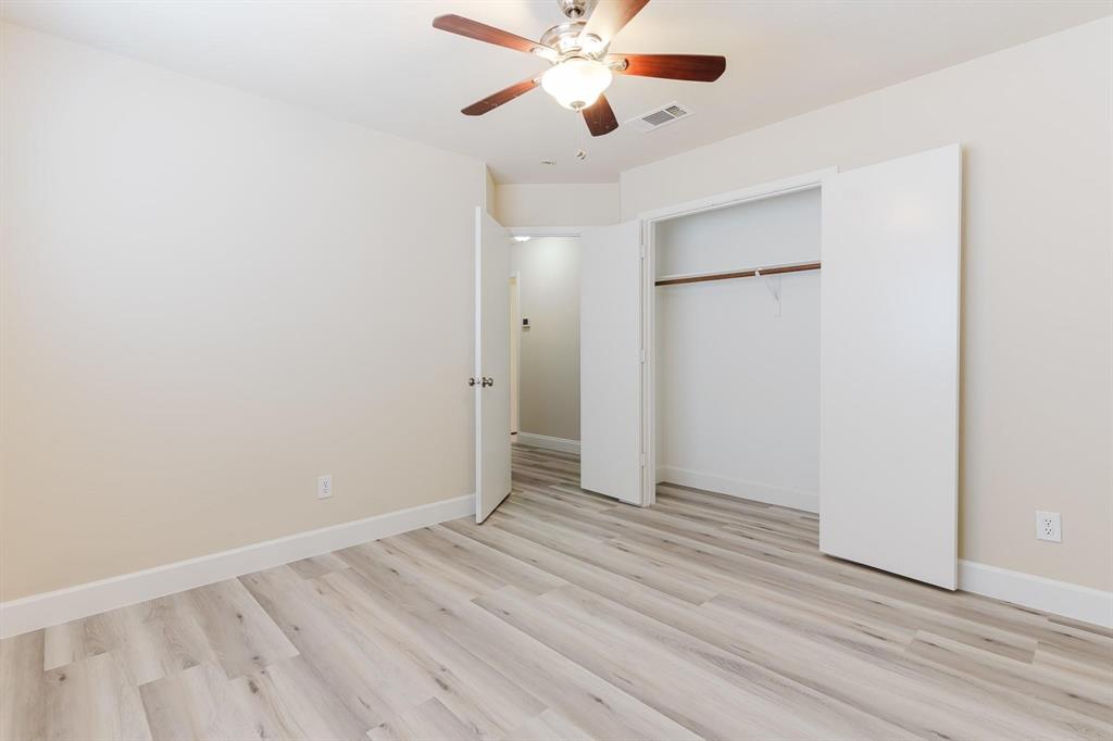 2109 Windjammer Way Rowlett, TX 75088 - Photo 14 of 21 Unfurnished bedroom with light wood-style flooring, a ceiling fan, and a closet
