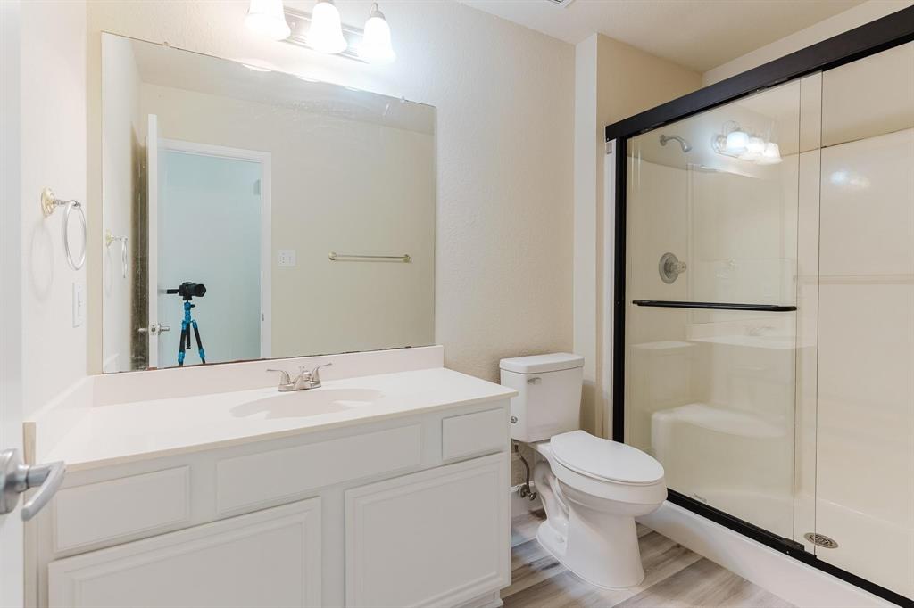 2109 Windjammer Way Rowlett, TX 75088 - Photo 16 of 21 Full bath featuring a stall shower, vanity, and light wood-style flooring