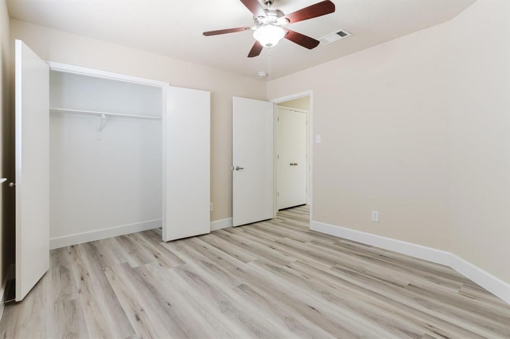 2109 Windjammer Way Rowlett, TX 75088 - Photo 17 of 21 Unfurnished bedroom with light wood finished floors, ceiling fan, and a closet