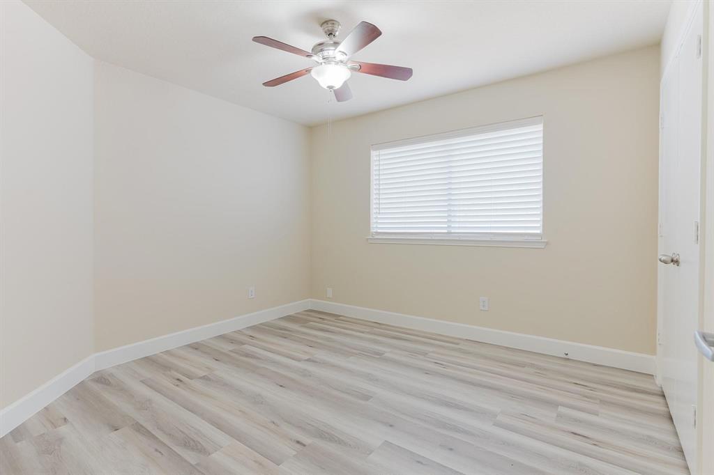 2109 Windjammer Way Rowlett, TX 75088 - Photo 18 of 21 Unfurnished room with light wood-style flooring and ceiling fan