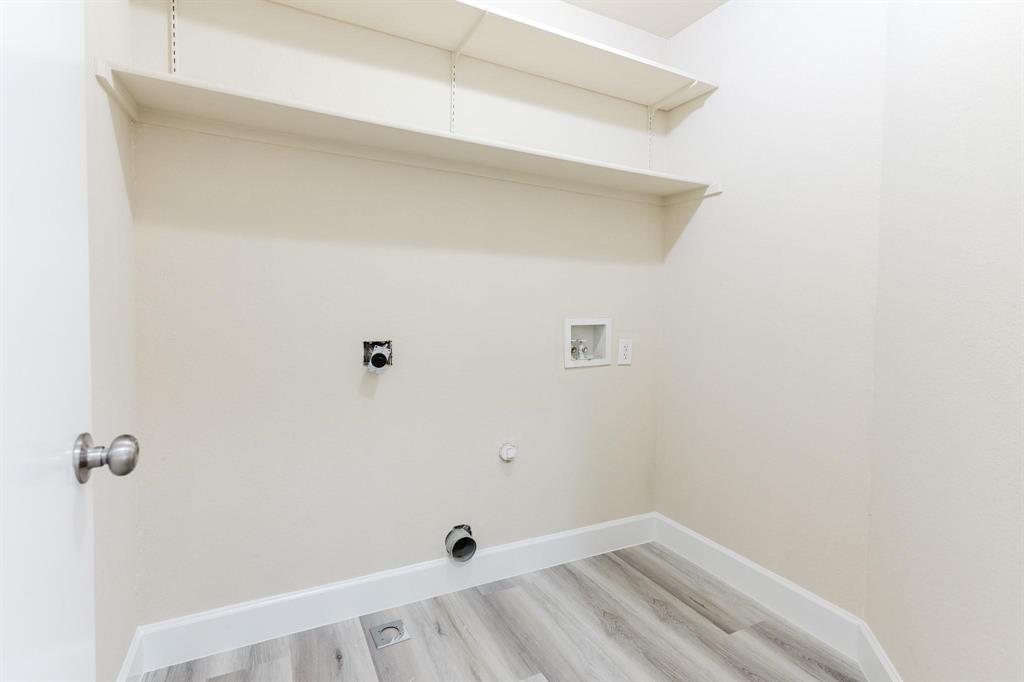 2109 Windjammer Way Rowlett, TX 75088 - Photo 19 of 21 Laundry room featuring hookup for a gas dryer, light wood-style flooring, hookup for a washing machine, and electric dryer hookup
