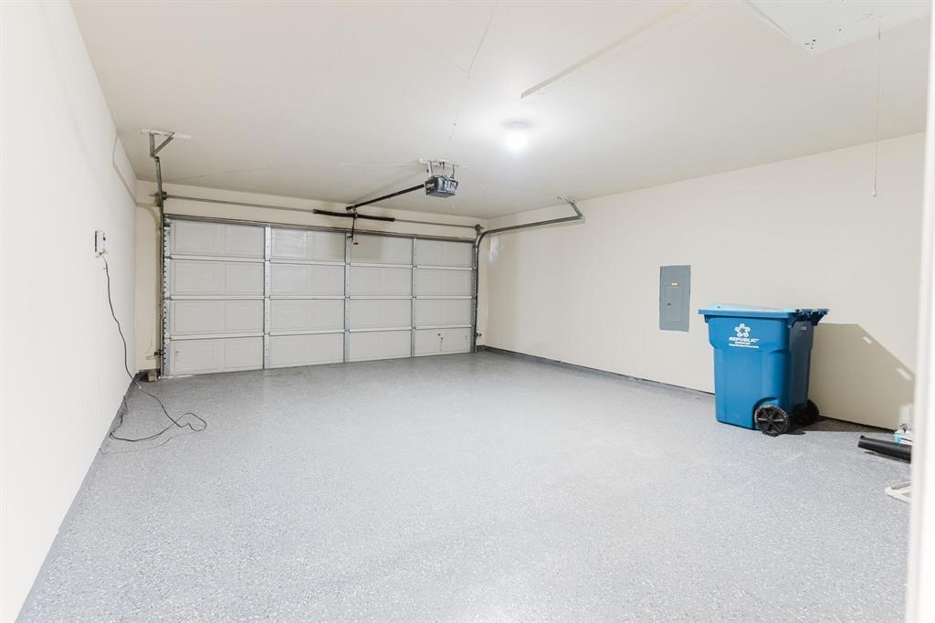 2109 Windjammer Way Rowlett, TX 75088 - Photo 20 of 21 Garage featuring electric panel and a garage door opener