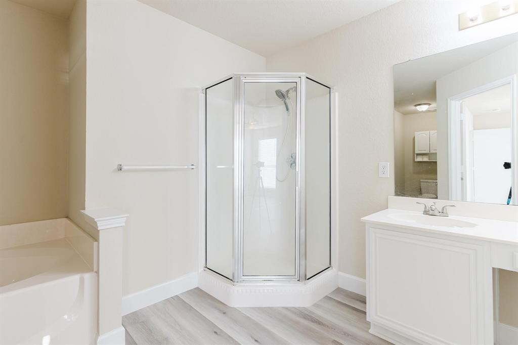 2109 Windjammer Way Rowlett, TX 75088 - Photo 8 of 21 Bathroom featuring vanity, a stall shower, a garden tub, and light wood-style floors