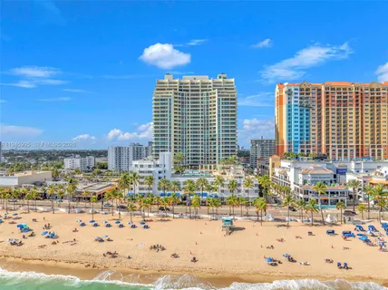 a dining room with furniture and a floor to ceiling window