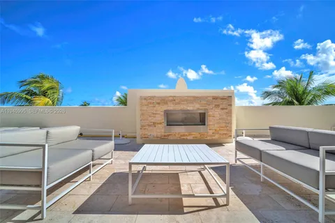 a view of a terrace with furniture and a kitchen